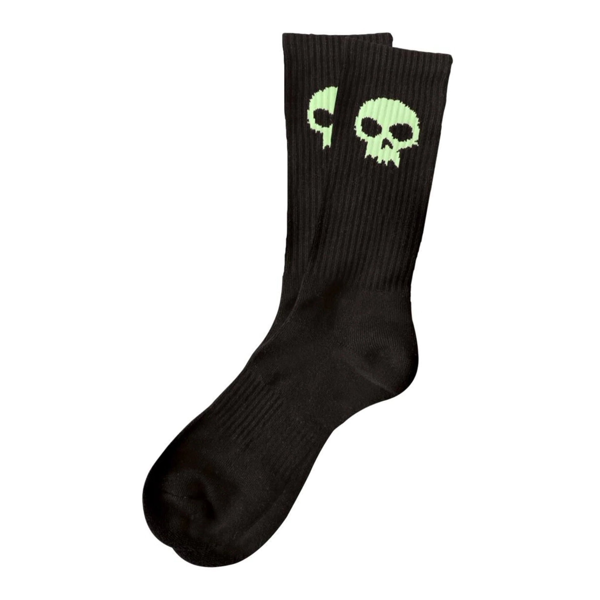 Black socks with green skull design on a white background