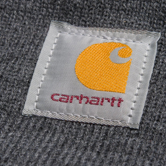 Carhartt logo label on a textured gray fabric background