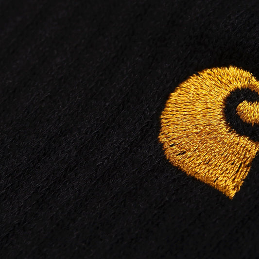 Black fabric with a gold embroidered logo on a white background