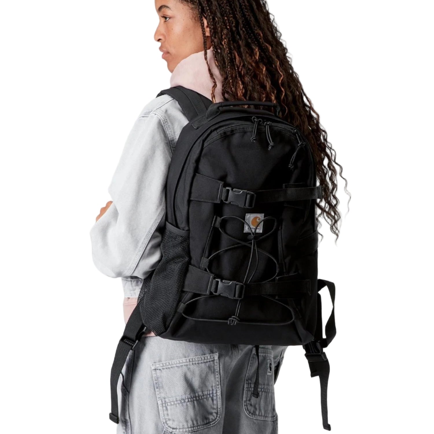 Person wearing a black backpack on a white background