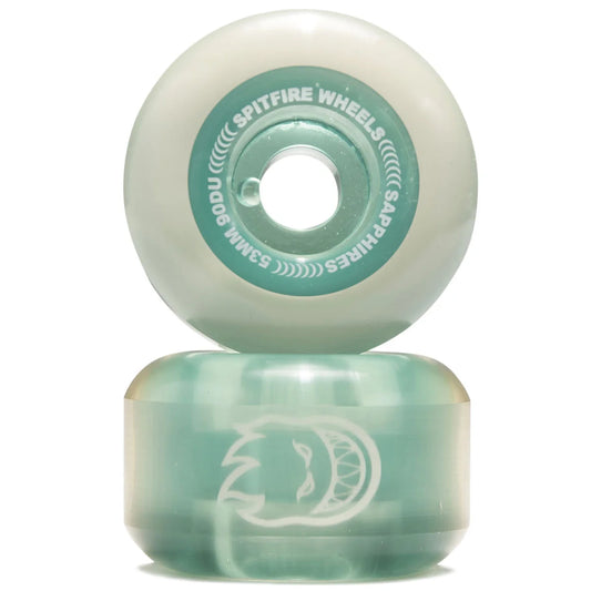Two mint green and white skateboard wheels stacked vertically on a white background. The top wheel shows the inner core with 'SPITFIRE WHEELS' and 'SAPPHIRES' branding, while the bottom wheel displays a white graphic logo.